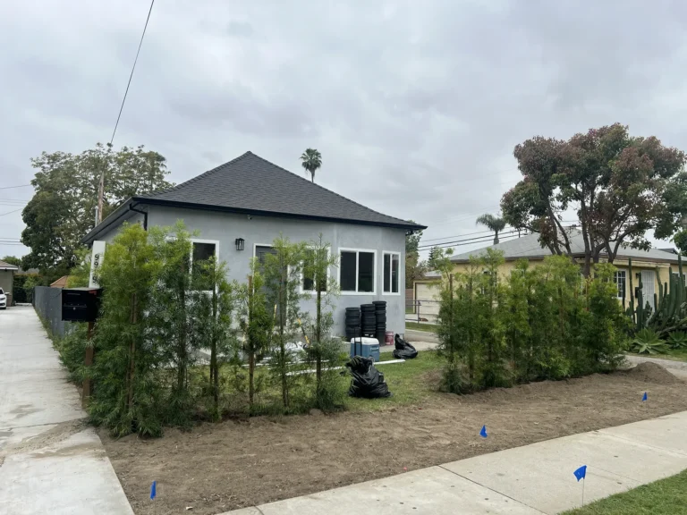 Remodeled Downey home exterior with new stucco, windows, roof, and landscaping