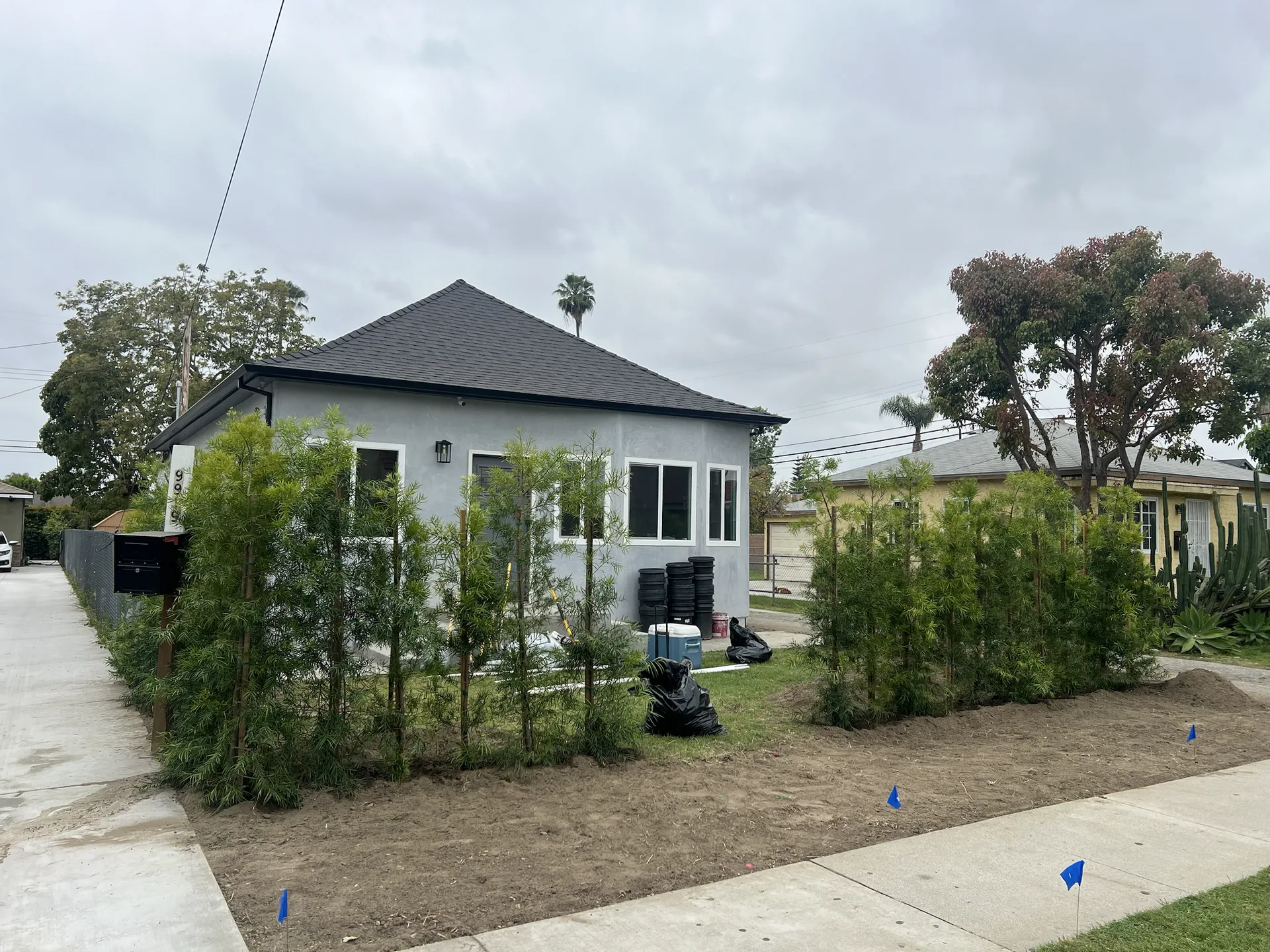 Remodeled Downey home exterior with new stucco, windows, roof, and landscaping